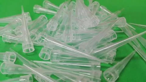 Close up view of micro litre tips on green floor sheet with empty holes. Rese Foto stock