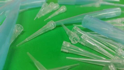 Close up view of micro litre tips on green floor sheet with empty holes. Rese Stock Photos