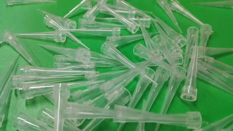 Close up view of micro litre tips on green floor sheet with empty holes. Rese Foto stock