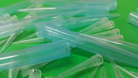 Close up view of micro litre tips on green floor sheet with empty holes. Rese Foto stock