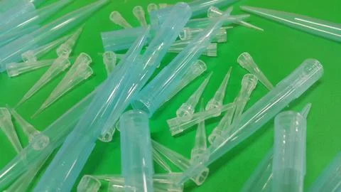 Close up view of micro litre tips on green floor sheet with empty holes. Rese Stock Photos