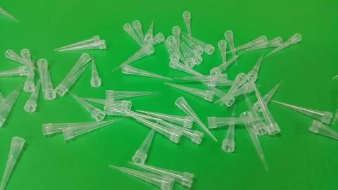 Close up view of micro litre tips on green floor sheet with empty holes. Rese Foto stock