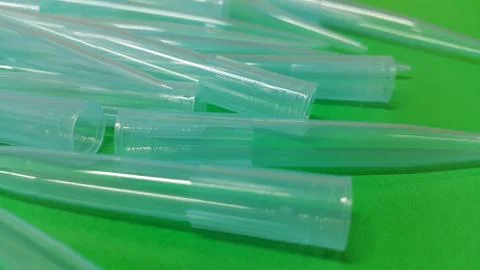 Close up view of micro litre tips on green floor sheet with empty holes. Rese Foto stock