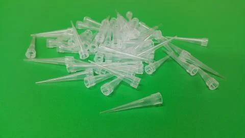 Close up view of micro litre tips on green floor sheet with empty holes. Rese Foto stock