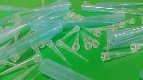 Close up view of micro litre tips on green floor sheet with empty holes. Rese Foto stock