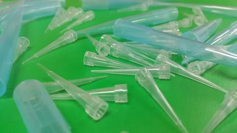 Close up view of micro litre tips on green floor sheet with empty holes. Rese Stock Photos