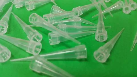 Close up view of micro litre tips on green floor sheet with empty holes. Rese Stock Photos