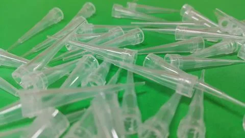 Close up view of micro litre tips on green floor sheet with empty holes. Rese Stock Photos