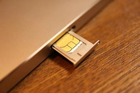 Close up view of a micro SIM card in a metal tray being inserted into a sma.. Stock Photos