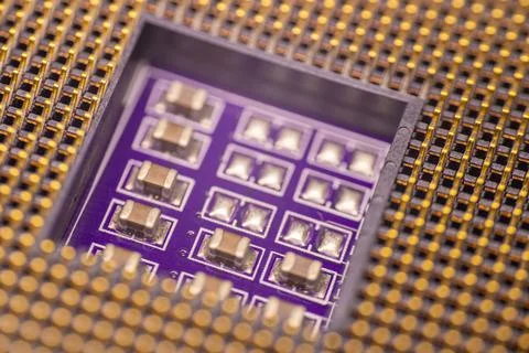 Close-up view of a microchip with multiple electronic components on a purpl.. Stock Photos