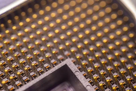 Close-up view of a microprocessor with intricate gold-plated pins arranged .. Stock Photos
