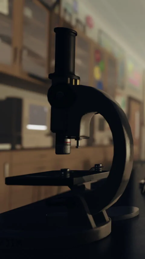 Close view of a microscope on a lab table in a classroom setting Stock Footage 335689160