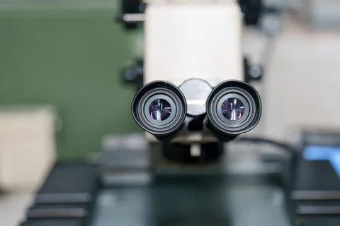 Close view of microscope lenses on a lab table during a science experiment .. Stock Photos