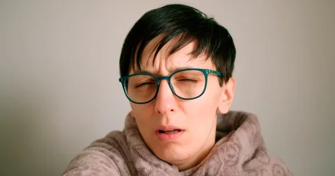 Close up view of a mid ages lady sneezing and coughing to elbow.Safe way Stock Footage 127191046