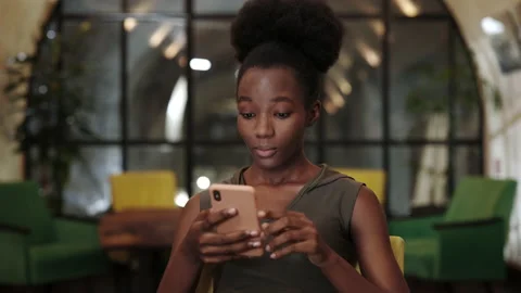 Close up view of millennial afro american woman looking amazed while using Video stock 152160803