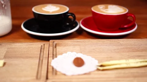 Close up view on minimalistic coffee cups with hot cappuccino drink with milk Video stock 104540860