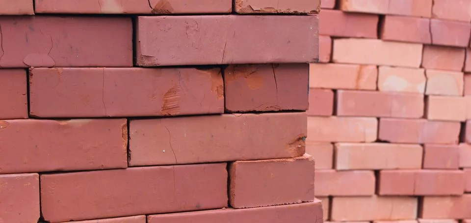 Close up view of minor damage on bricks stacked in cubic columns Stock Photos