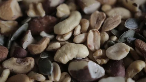 Close up view of a mix of Brazil and Cashew nuts and seeds for snack Vídeo Stock 155604773