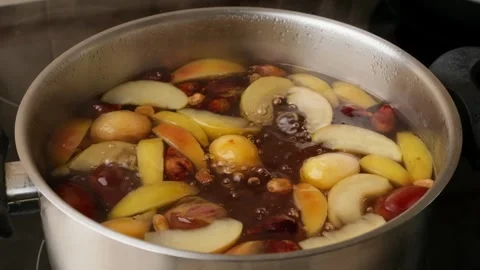 Close-up view of mixed apple, apricot, rosehip and date compote, slow motion Stock Footage 308302748
