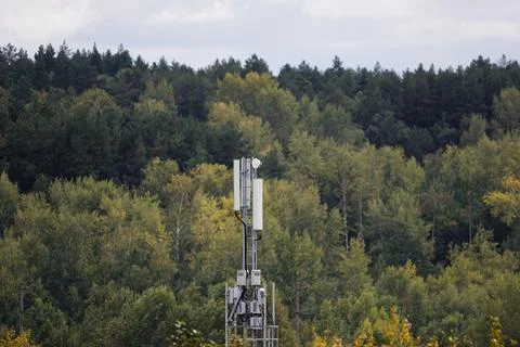 A close-up view of a mobile network antenna or telecommunications mast rising 스톡 사진