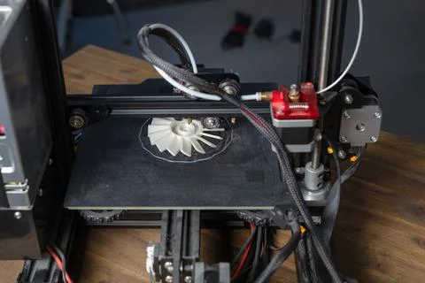 Close view of modern 3D printer producing a prototype in a clean workspace Stock Photos
