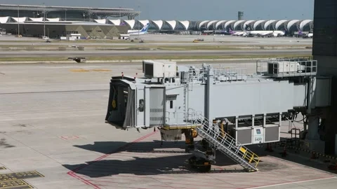 A close view of a modern aircraft jet bridge connected to a terminal Stock Footage 341481712
