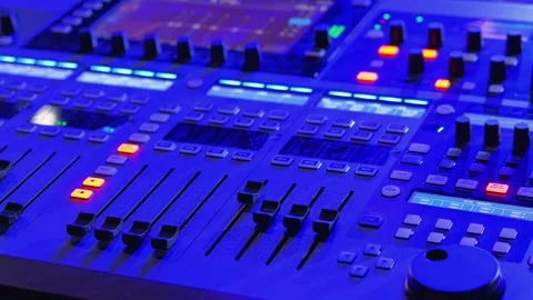 A close-up view of a modern audio mixing console featuring multiple sliders Stock Footage 305751879