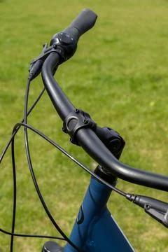 Close-up view of modern bicycle handlebars with ergonomic grips, black brak.. Stock Photos