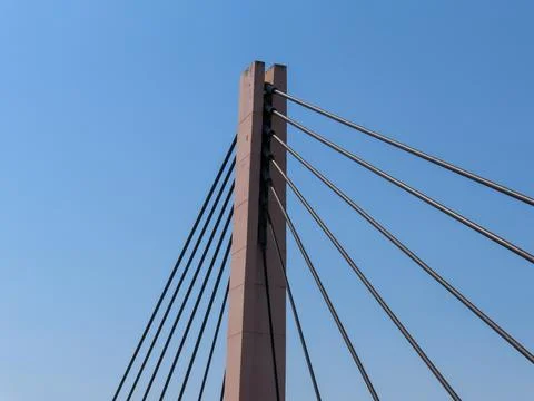 Close-up view of a modern cable-stayed bridge pylon with steel cables Stock Photos