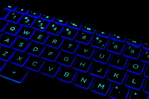 Close up view of a modern laptop computer keyboard keys. Soft lightning in gr Stock Photos
