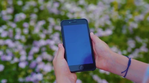 Close up view of modern phone in vertical position being held by unrecognizable Stock Footage 113045330