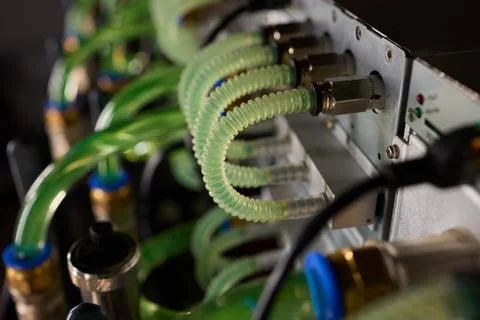 Close-up view of modern server hardware with liquid cooling pipes ensuring op Stock Photos