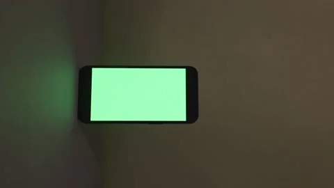 Close-up view of modern smartphone with green screen on green background, blank Video stock 165041895