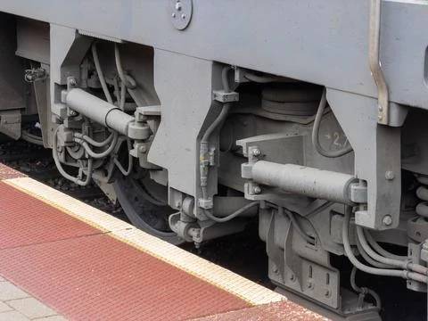 A close view of a modern train bogie with suspension systems resting on a 스톡 사진