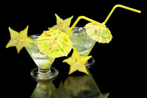 Close-up view of mojito drinks with ice cubes on a party on black background Stock Photos