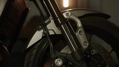 Close-up view of a motorcycle front fork showcasing suspension details in a diml Stock Footage 326823668