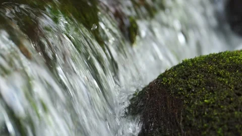 Close-up view of mountain river waterfall splash, slow motion. Video stock 323224393