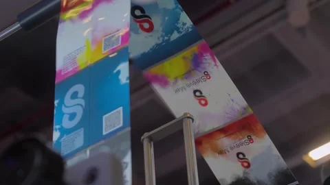 Close up view of moving colorful label tape - part of label printing machine Stock Footage 343861525