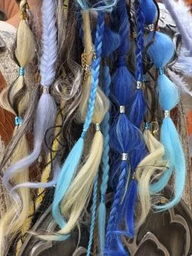 Close up view of multi colored hair braids and dreadlocks in blue and blond.. Foto stock
