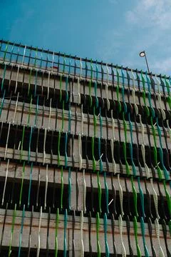 Close view of a multi storey car parking garage with green facade elements an Stock Photos