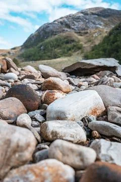 Close up view of multicolored large river rocks on a mountain river bed Photos