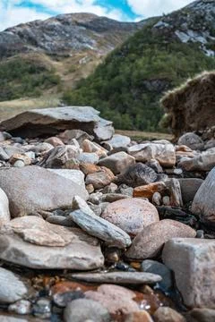 Close up view of multicolored large river rocks on a mountain river bed Stock Photos