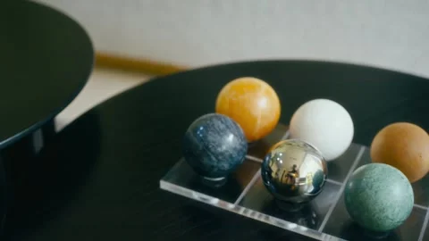 Close-up view of multicolored spheres on a black table Video stock 345400843
