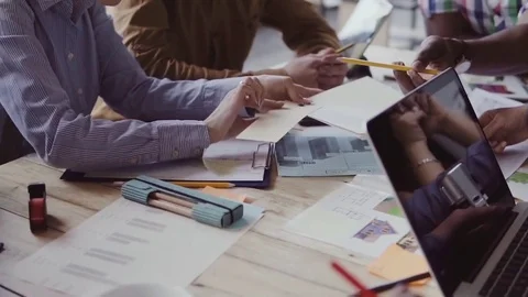 Close-up view of multiethnic group of people working at the table. Creative Stock-Footage 84328035