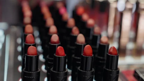 Close-up view of multiple rows of assorted lipstick shades arranged in a display Stock Footage 310351978