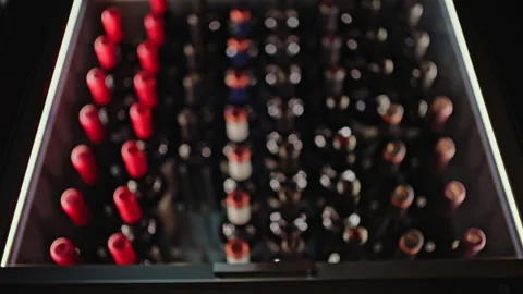 Close up view of multiple wine bottles arranged in rows inside a storage display Stock Footage 335561759