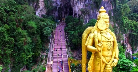 Close view of the Murugan statue and many stairs of entrance to the Batu Caves Stock Footage