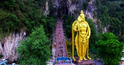 Close view of the Murugan statue and many stairs of entrance to the Batu Caves Stock Footage