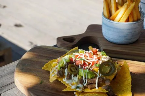 Close up view of nachos on the table. Good illustration for meal on vacation. Stock Photos