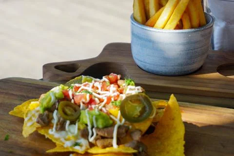 Close up view of nachos on the table. Good illustration for meal on vacation. Stock Photos